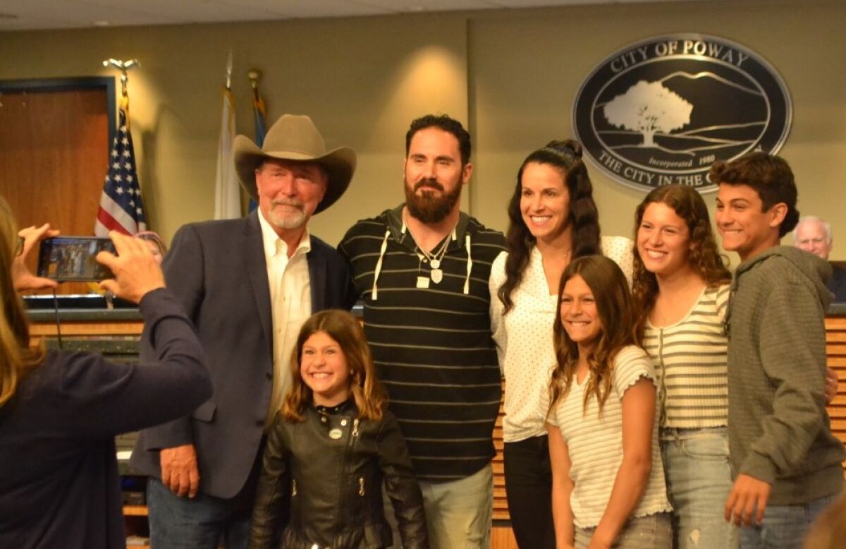 Poway Mayor Steve Vaus poses for a picture with Super Bowl champion Eric Weddle, his wife, Chanel, and their four children.