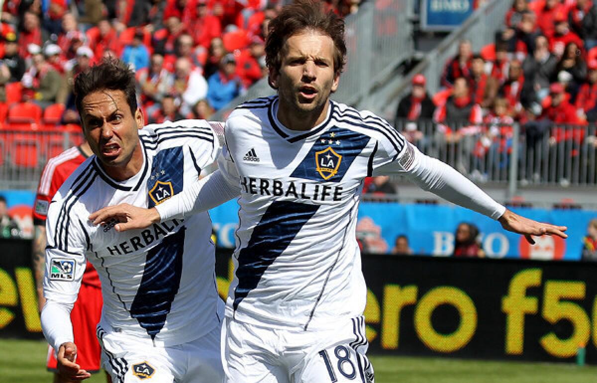 Galaxy forward Mike Magee (18) celebrates a goal with teammate Marcelo Sarvas in an MLS game against Toronto FC on Saturday.