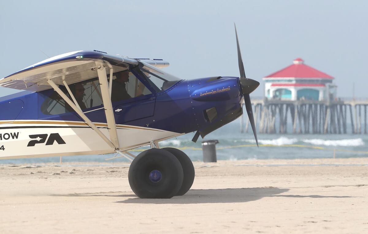 A STOL plane makes a landing on the sand during the Pacific Airshow press conference on the beach on Thursday.