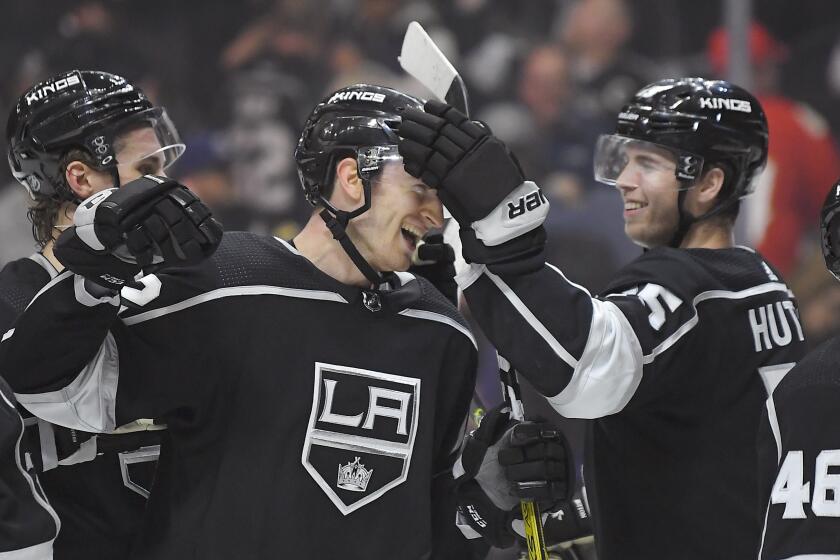 Los Angeles Kings center Gabriel Vilardi, center, is congratulated by defenseman Ben Hutton after an NHL hockey game against the Florida Panthers Thursday, Feb. 20, 2020, in Los Angeles. Vilardi scored a goal in the first period. The Kings won 5-4. (AP Photo/Mark J. Terrill)
