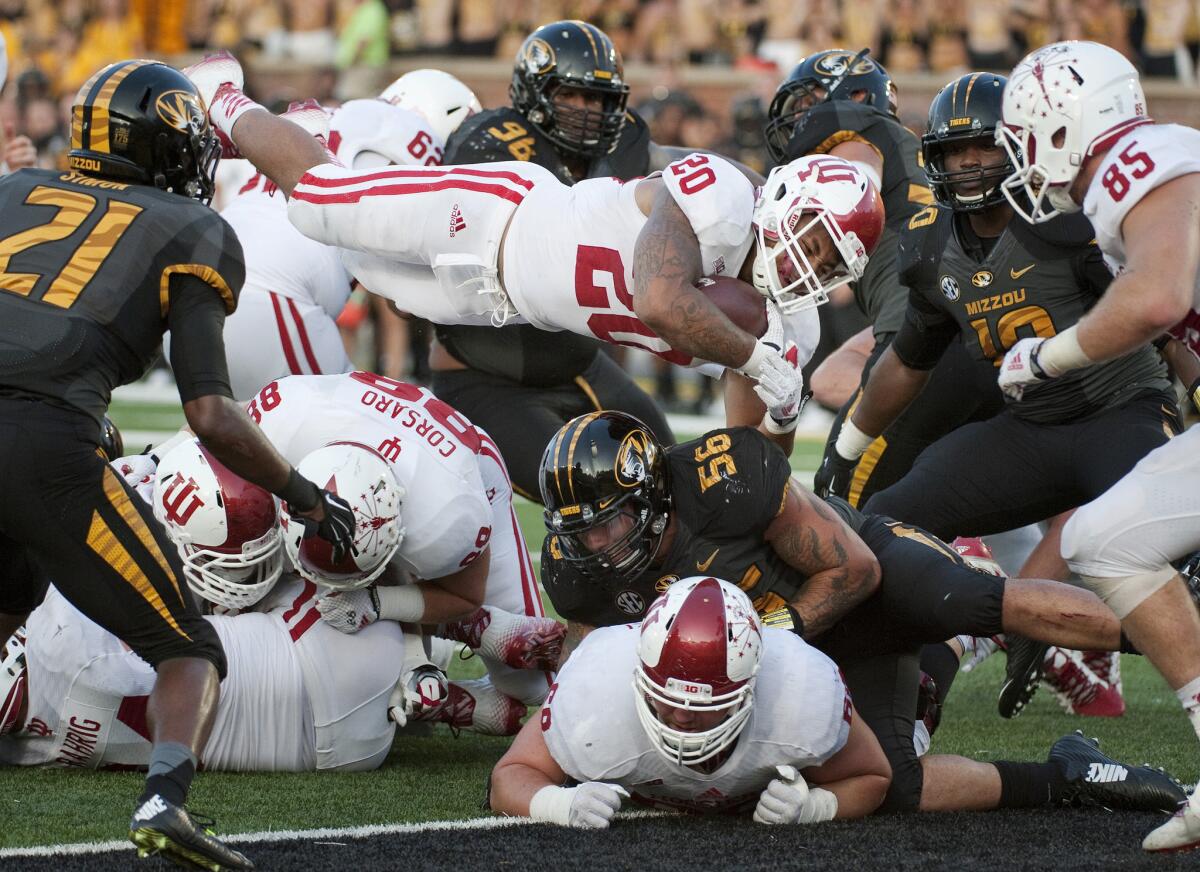 Indiana running back D'Angelo Roberts, center, leaps into the end zone for the game-winning touchdown late in the the fourth quarter of the Hoosiers' 31-27 upset victory.