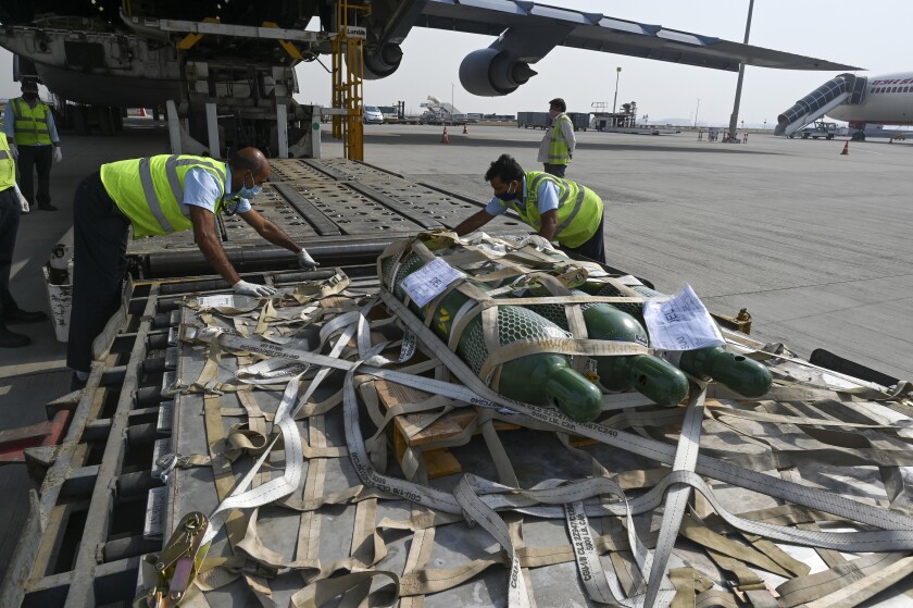 FILE - In this April 30, 2021, file photo, relief supplies from the United States in the wake of India's COVID-19 situation arrive at the Indira Gandhi International Airport cargo terminal in New Delhi, India. India’s large diaspora is tapping its wealth, growing political clout and expertise to help India combat a catastrophic coronavirus surge that has led to desperate pleas for oxygen and left people to die outside overwhelmed hospitals. (Prakash Singh/Pool via AP, File)