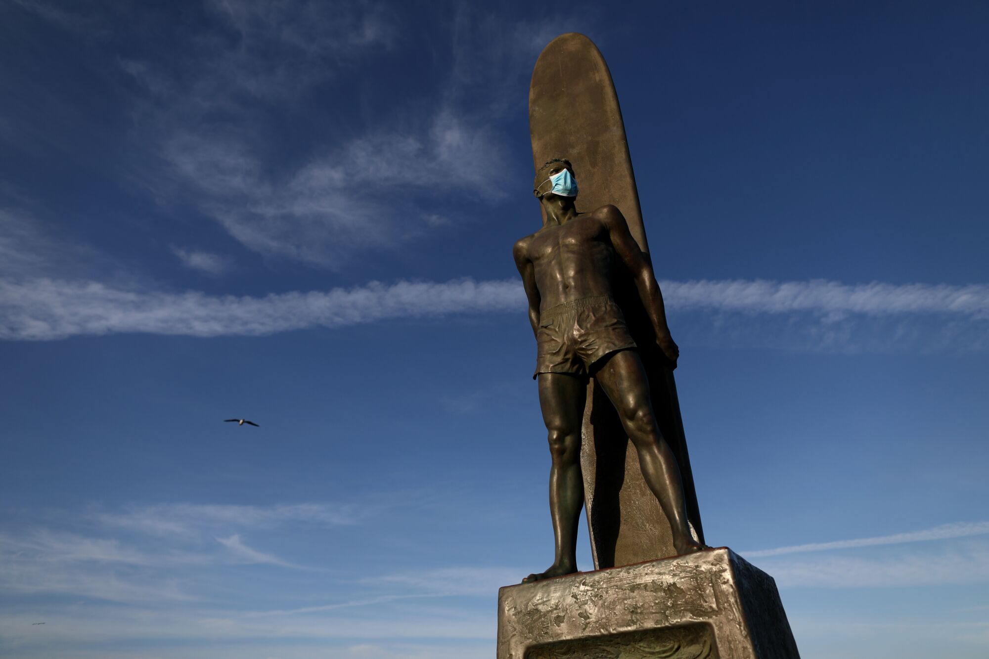 Surfers Memorial, where someone has left a protective mask, at Steamer Lane in Santa Cruz.