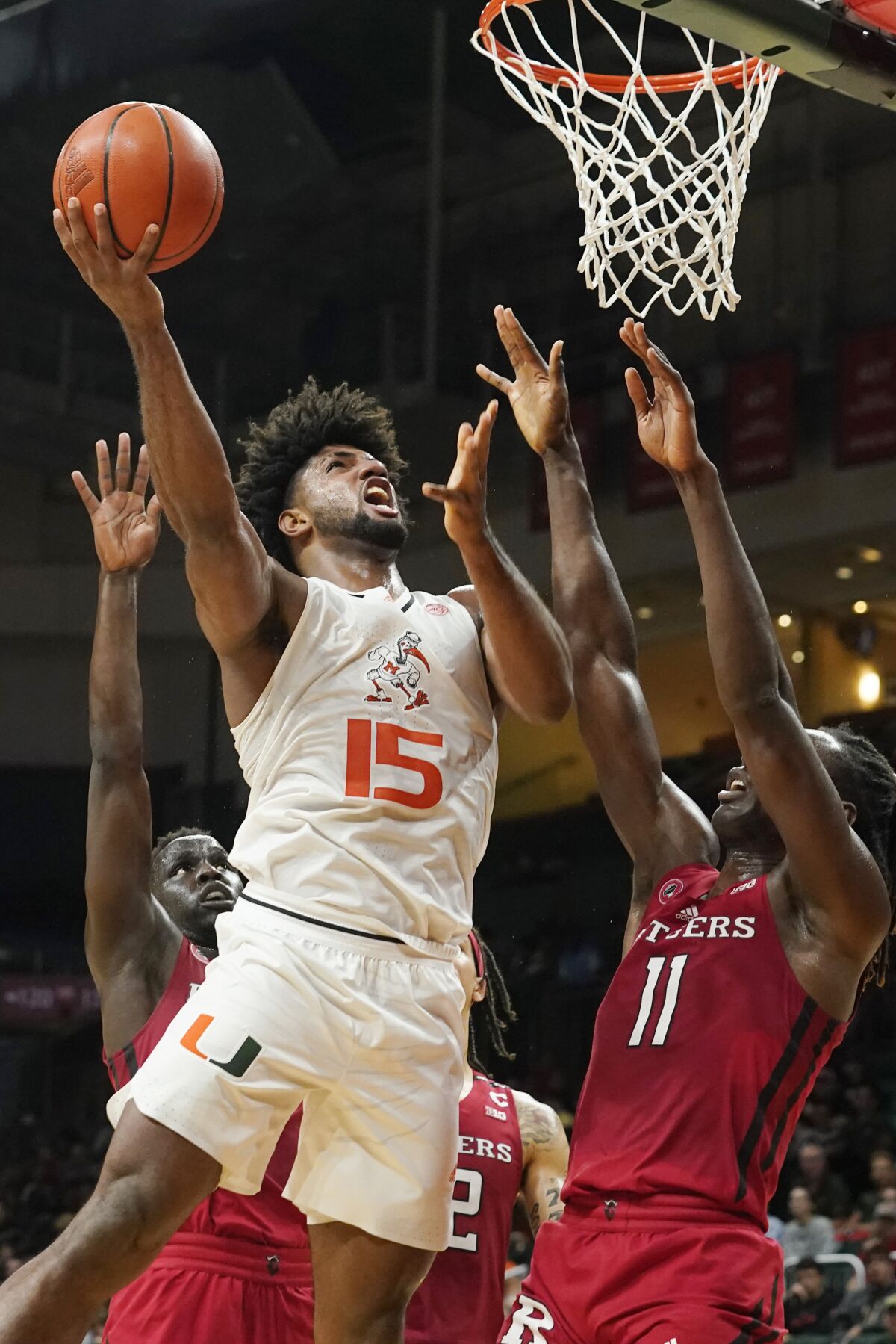 Miami's forward Norchad Omier (15) drives to the basket over Rutgers' center Clifford Omoruyi (11) during the first half of an NCAA college basketball game, Wednesday, Nov. 30, 2022, in Coral Gables, Fla. (AP Photo/Marta Lavandier)