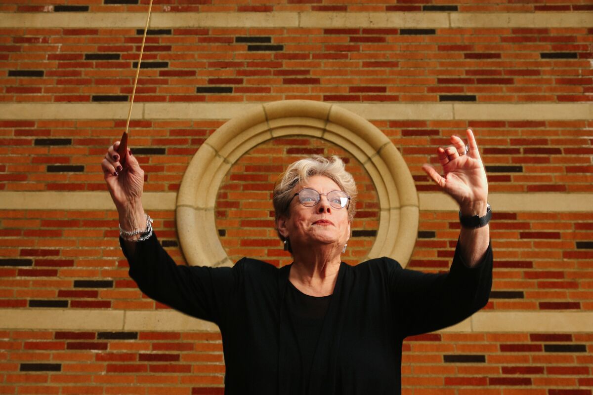 A female choir conductor dressed in black.