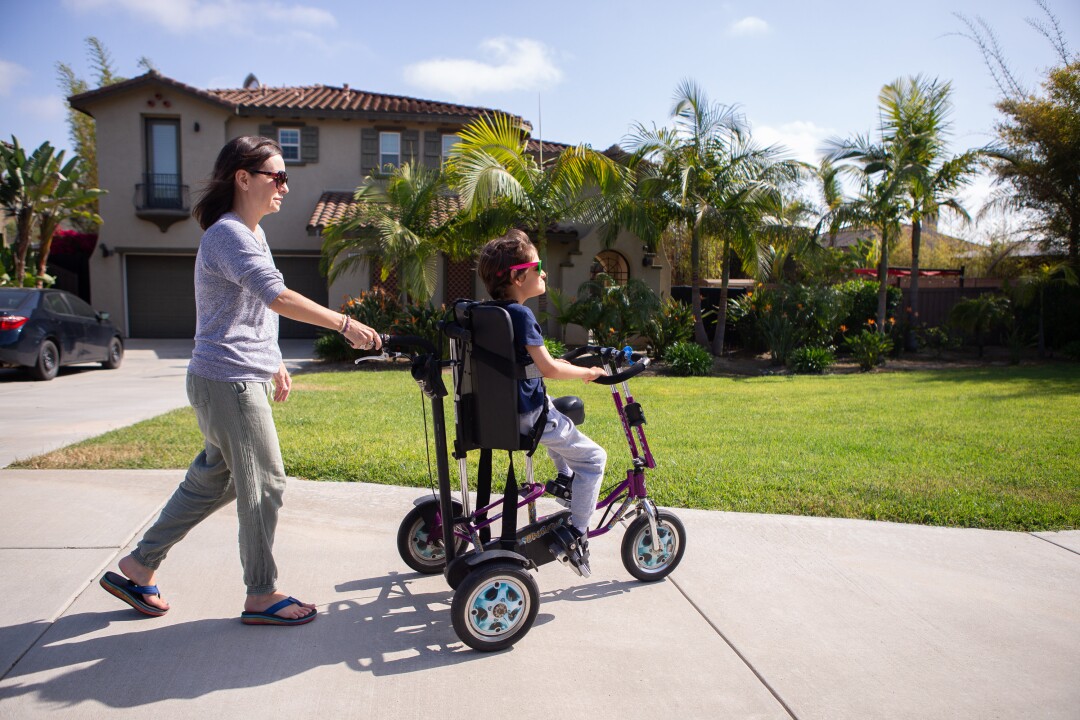 Kelley Dalby takes her son Connor Dalby, 12, on a bike ride around their neighborhood.