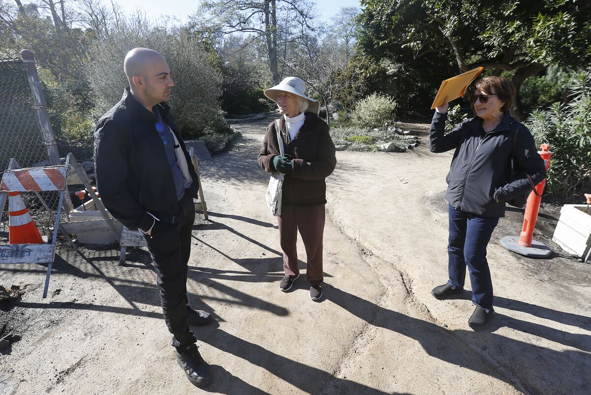 Joe Thome, Juana Mueller and Betty Reinertson compare notes at the Secret Garden.