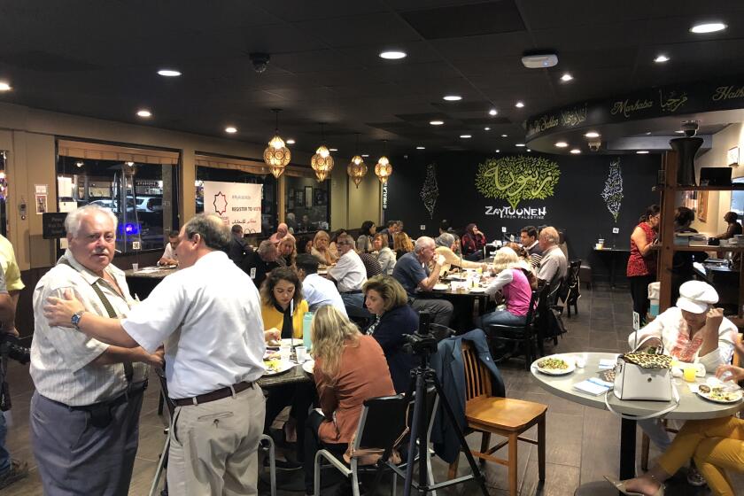 Groups of diners enjoy their meals at Olive Tree Restaurant in Anaheim. Olive Tree Restaurant closed during the pandemic.