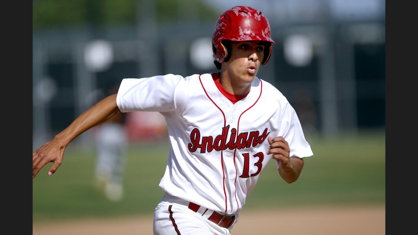 Burroughs High School baseball player #13 Daniel Leonard got on his horse and came around from second base to score a run in home game vs. Arcadia High School at the Indian's Tomahawk field in Burbank on Friday, April 28, 2017.