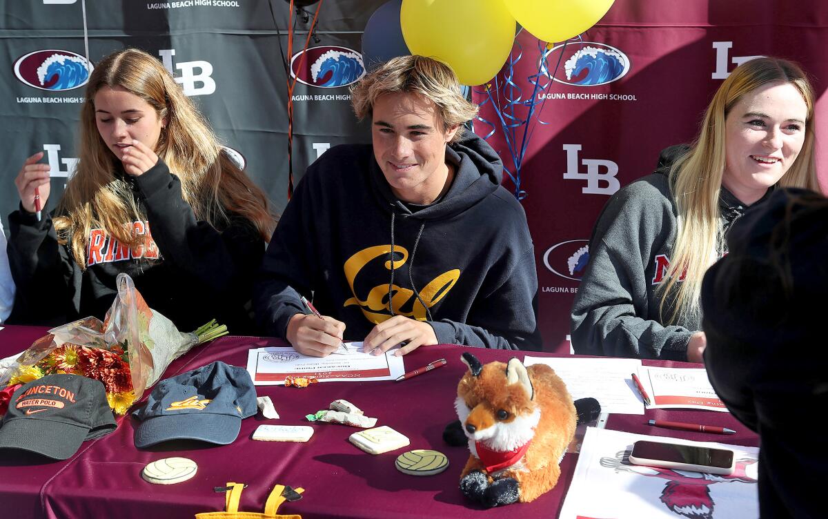 Laguna Beach water polo players Ava Houlahan, William Kelly and Lela McCarroll from left, sign their letters of intent.