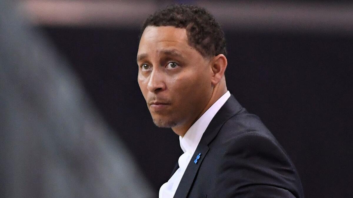 Former Southern California assistant coach Tony Bland stands on a basketball court 