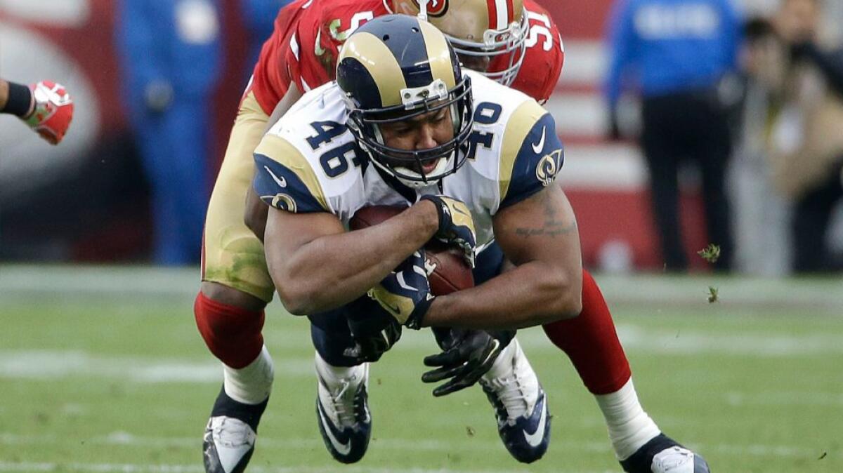 Rams tight end Cory Harkey is tackled by 49ers linebacker Gerald Hodges during a game on Jan. 3.