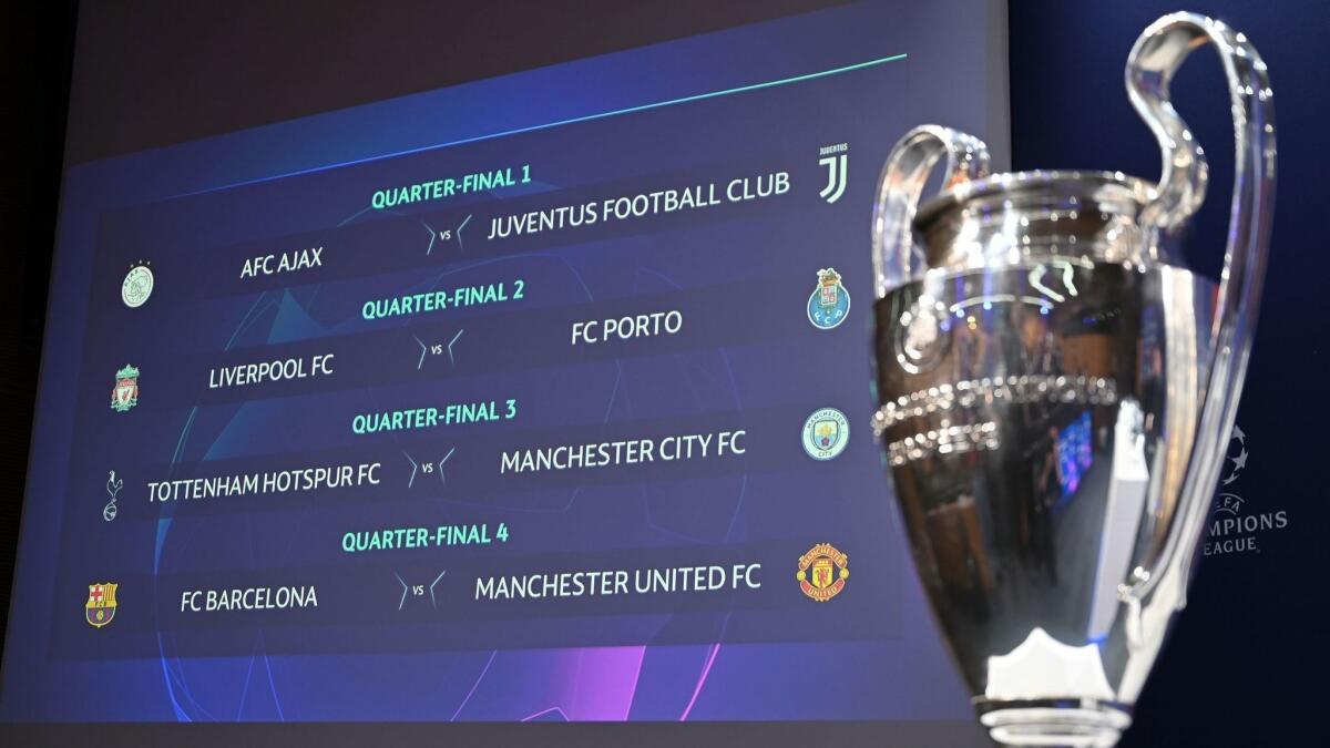 The results of the draw for the Champions league quarterfinal is displayed next to the competition's trophy.