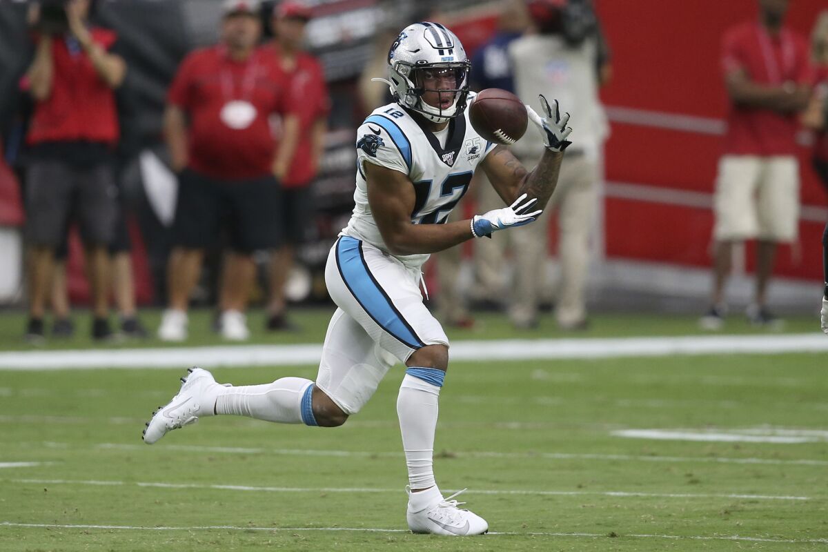 Carolina Panthers wide receiver D.J. Moore makes a running catch during a game.