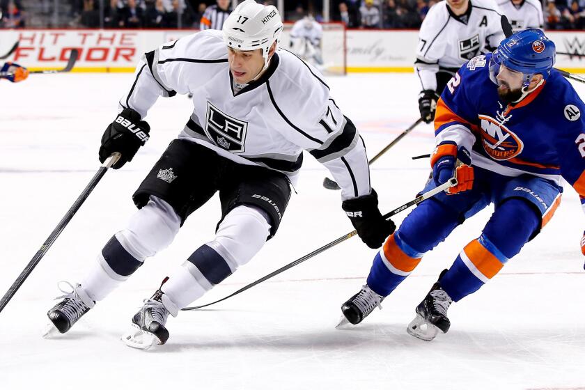 Kings left wing Milan Lucic tries to protect the puck from Islanders defenseman Nick Leddy during their game Thursday night at Barclays Center.