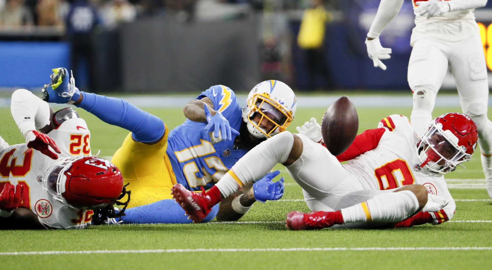 Chargers wide receiver Keenan Allen fumbles the ball against Chiefs safety Bryan Cook and linebacker Nick Bolton.