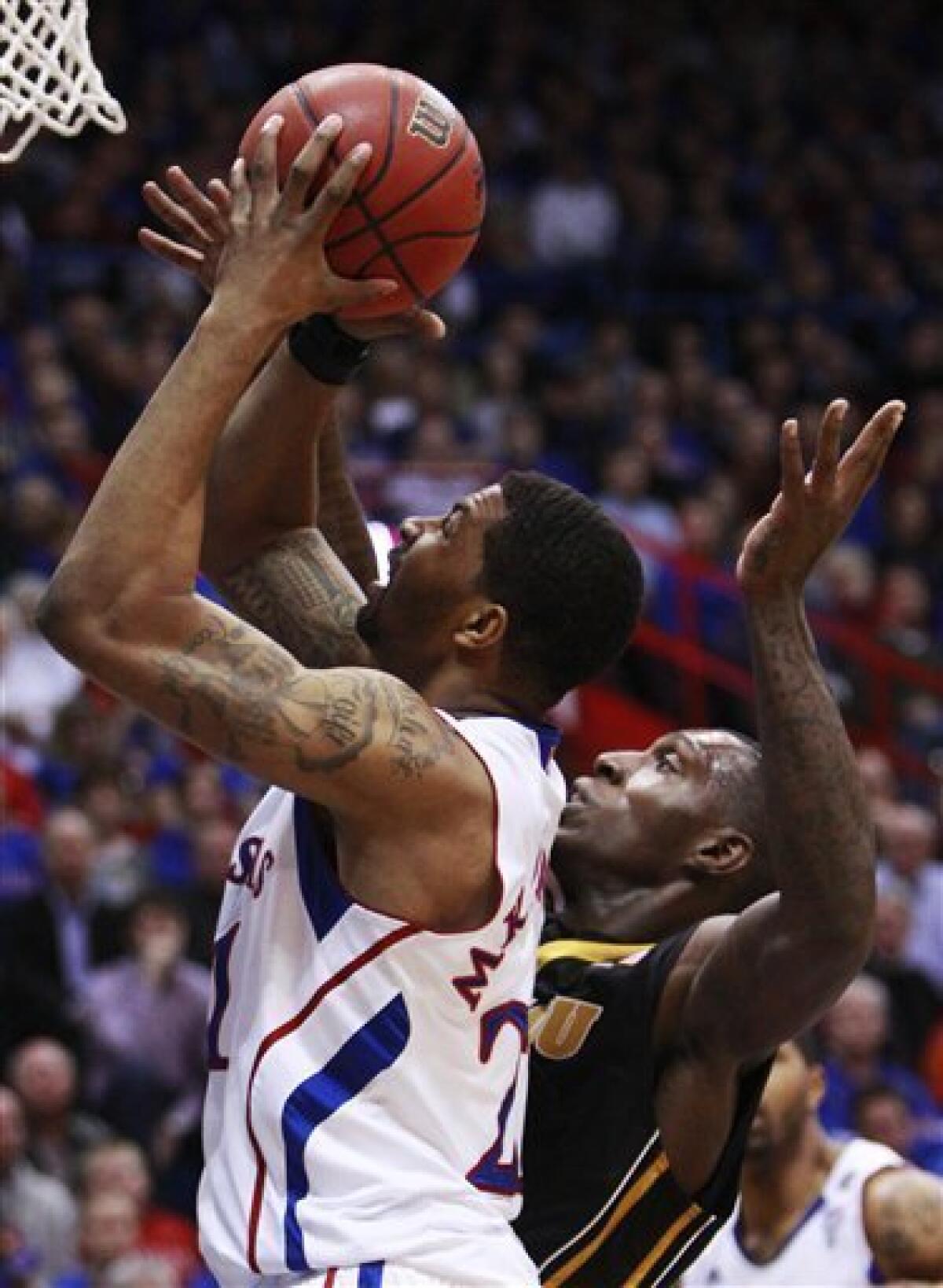 Kansas' Markieff Morris (21) with his twin brother Marcus Morris, left,  during the second half of an NCAA college basketball game against La Salle  Saturday, Dec. 12, 2009 in Kansas City, Mo. (