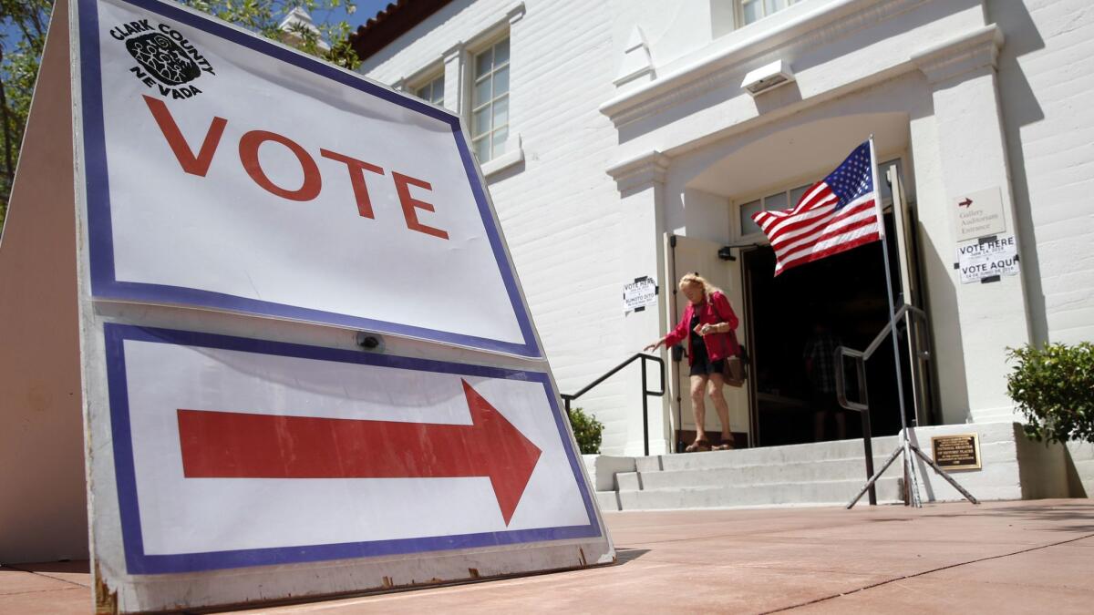 A woman walks out of a polling place after voting in the Nevada primary election in Las Vegas on June 14, 2016.