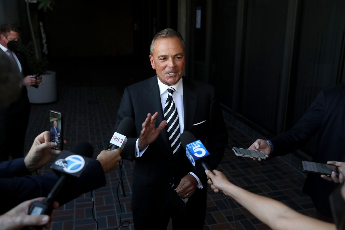 Rick Caruso leaves the city clerk’s office on Friday after filing paperwork to run for mayor of Los Angeles.