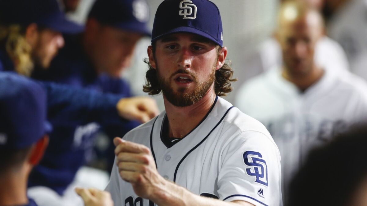 Padres starting pitcher Bryan Mitchell fist bumps teammates after the third inning against the San Francisco Giants on Sept. 17, 2018.