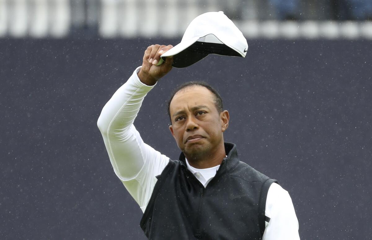 Tiger Woods waves his cap at the British Open