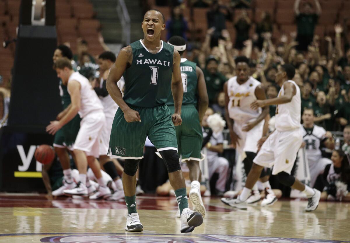Hawaii guard Garrett Nevels celebrates a teammate's basket in the Rainbow Warriors' 79-72 victory over Long Beach State.