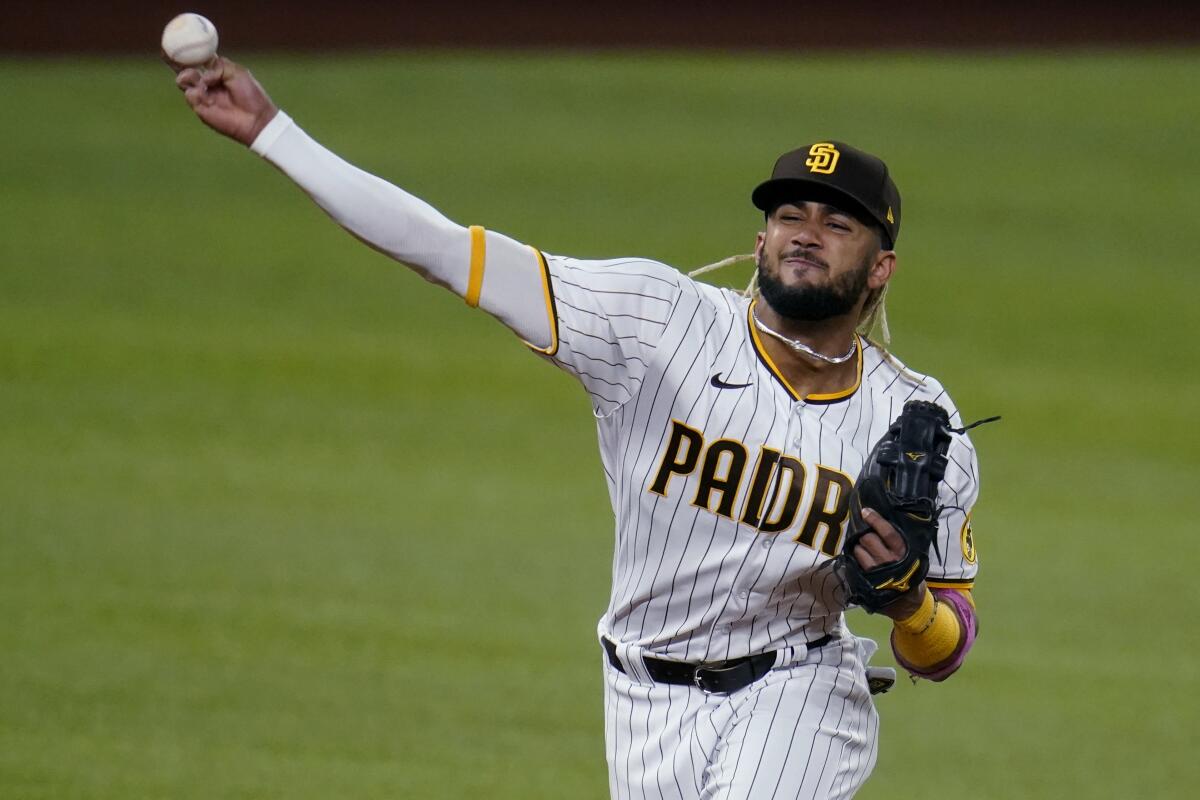Padres shortstop Fernando Tatis Jr. throws to first base during Game 3 of the NLDS on Thursday.