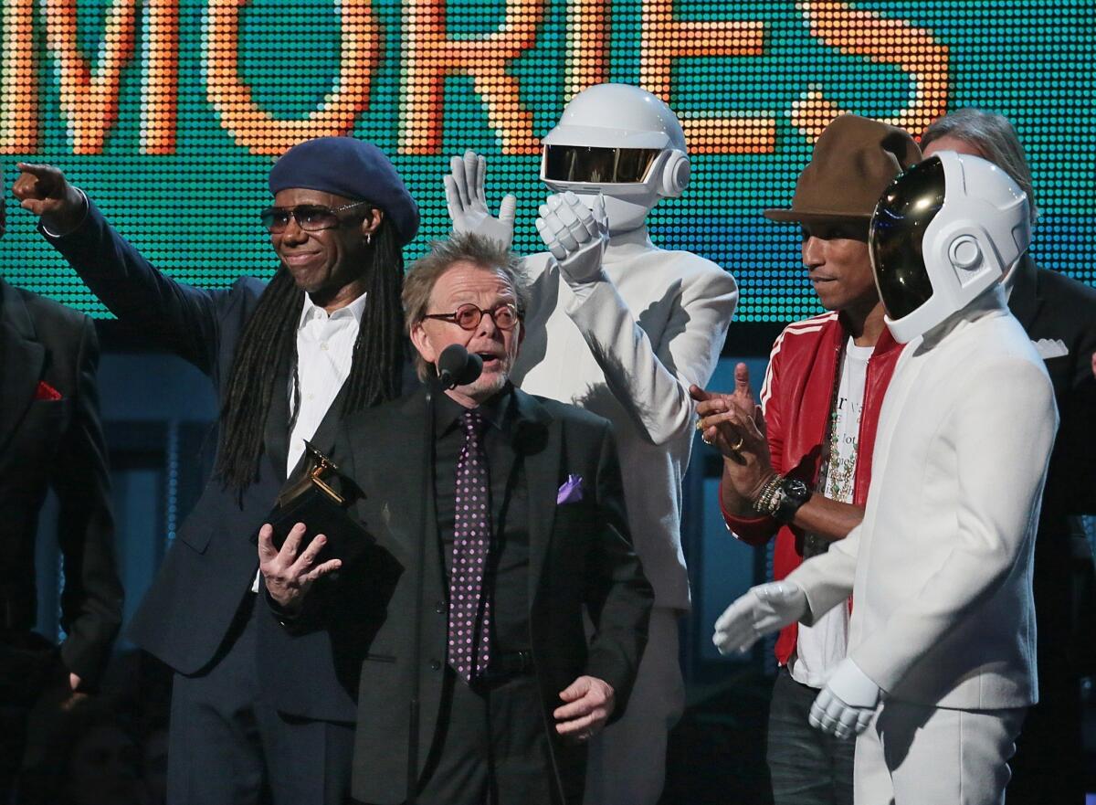 Paul Williams accepts the Grammy and speaks after the album of the year win for Daft Punk's "Random Access Memory" on Sunday night. Behind him are Nile Rodgers, left, a Daft Punk member, Pharrell Williams and the second Daft Punk member.