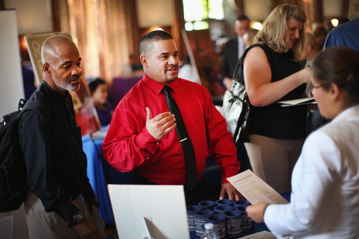 Military veterans research employment opportunities at the Hiring Our Heroes jobs fair for vets at the University of Chicago on Wednesday.