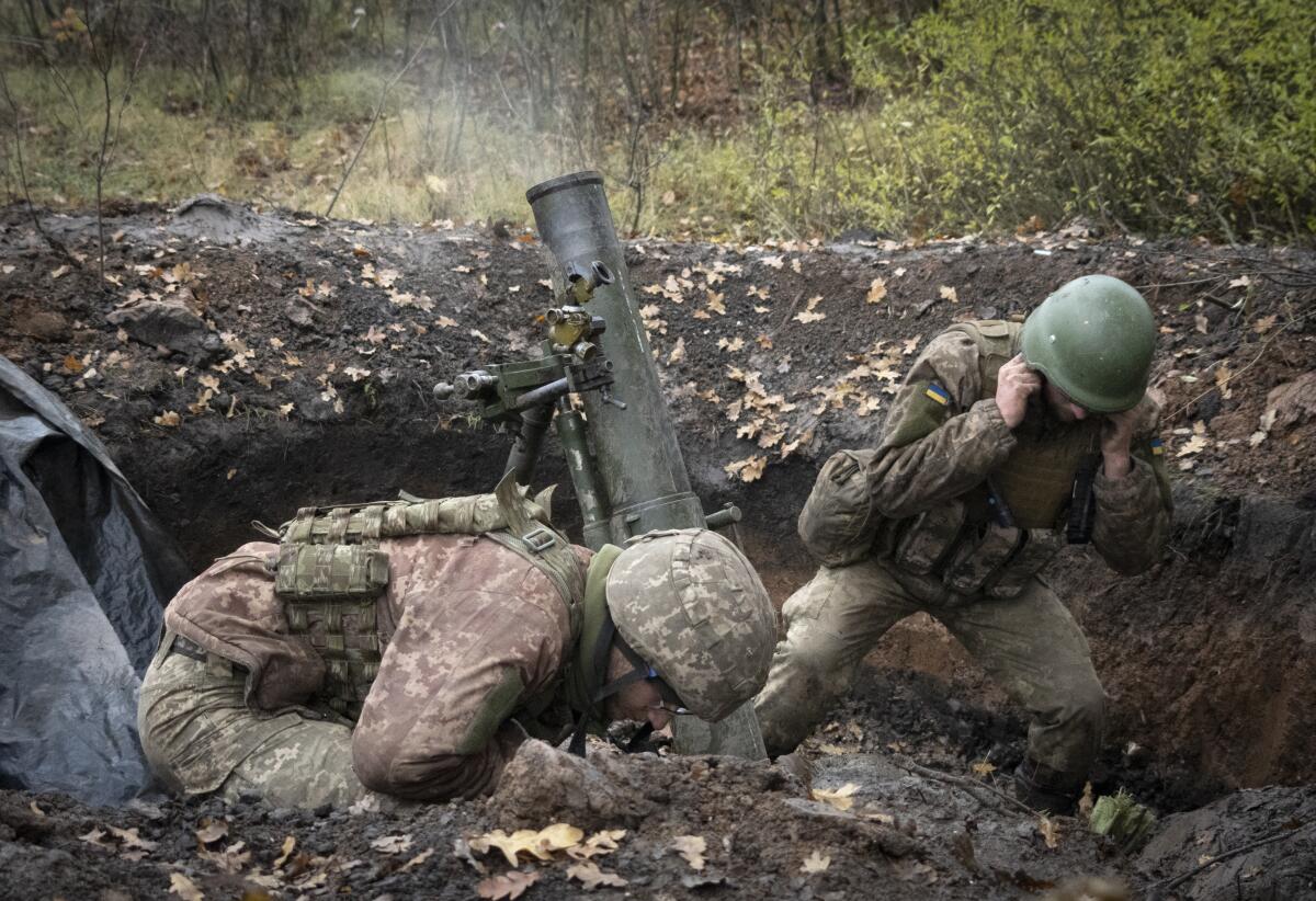 Ukrainian soldiers firing a mortar