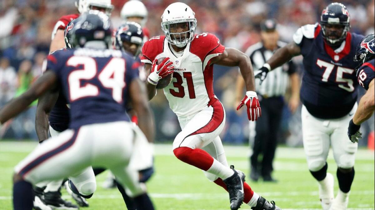 Cardinals running back David Johnson looks for room to run against the Texans during an exhibition game on Aug. 28.