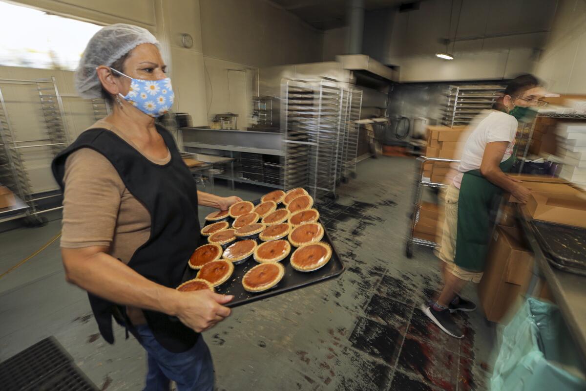 Guadalupe Valdovinos, left, packs pies at 27th Street Bakery Shop.