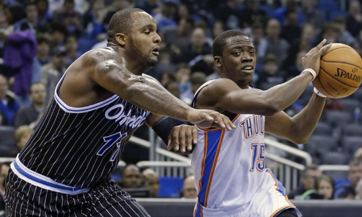 Orlando Magic forward Glen Davis, left, guards Oklahoma City's Reggie Jackson during a Feb. 7 game. Davis signed with the Clippers on Monday, but did not play in the team's win over the New Orleans Pelicans.