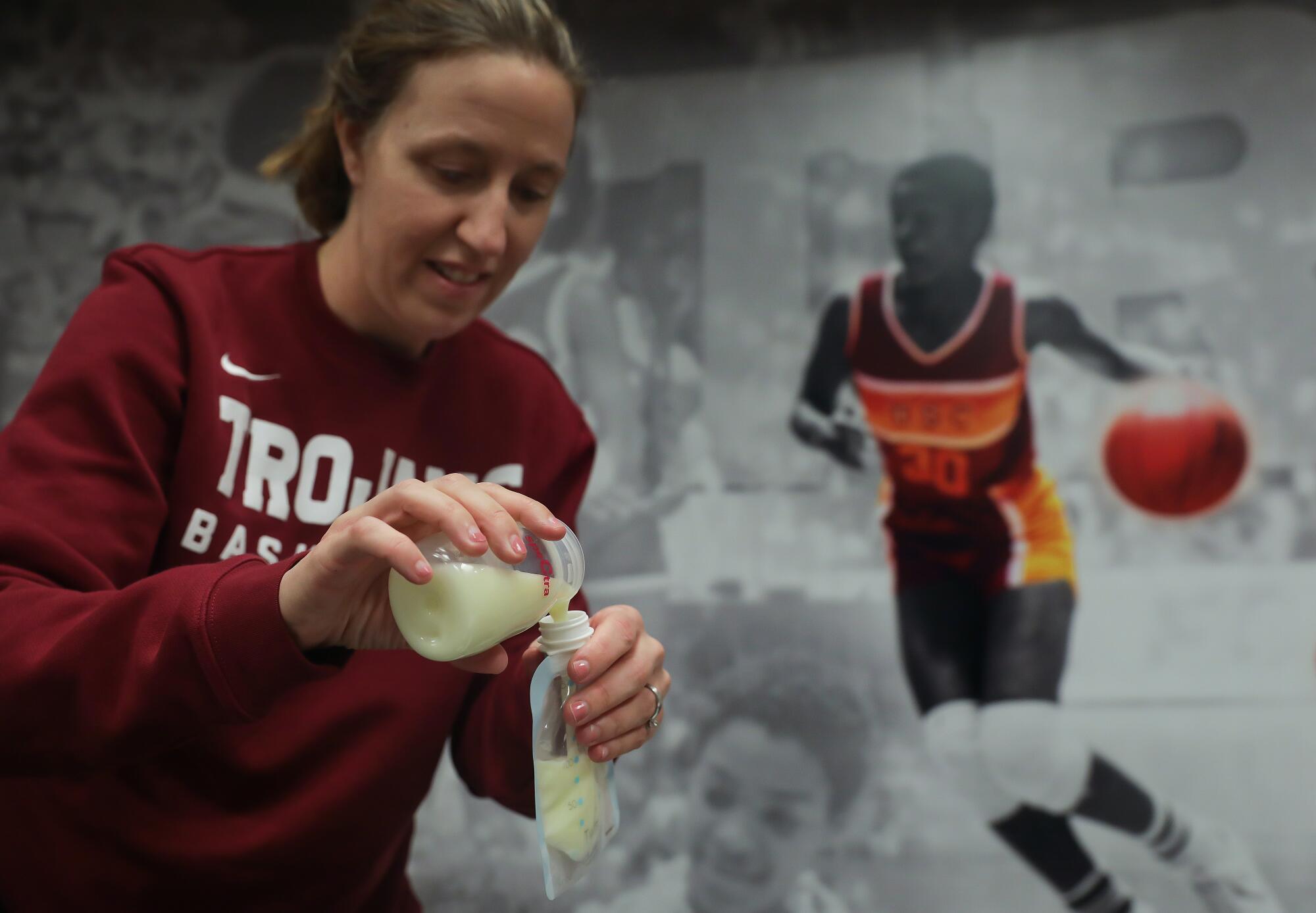 USC women's basketball head coach Lindsay Gottlieb pumps breastmilk in her office during a team practice.