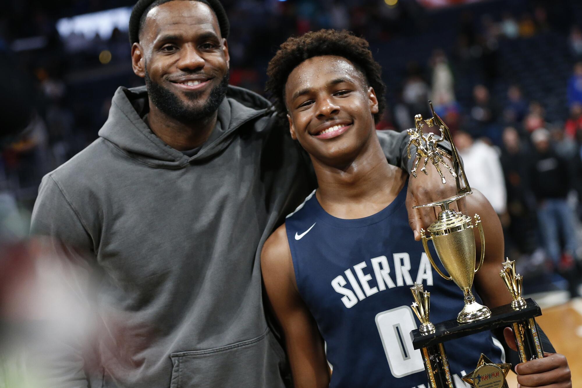 LeBron James poses for a photo next so son Bronny when he starred at Sierra Canyon High.
