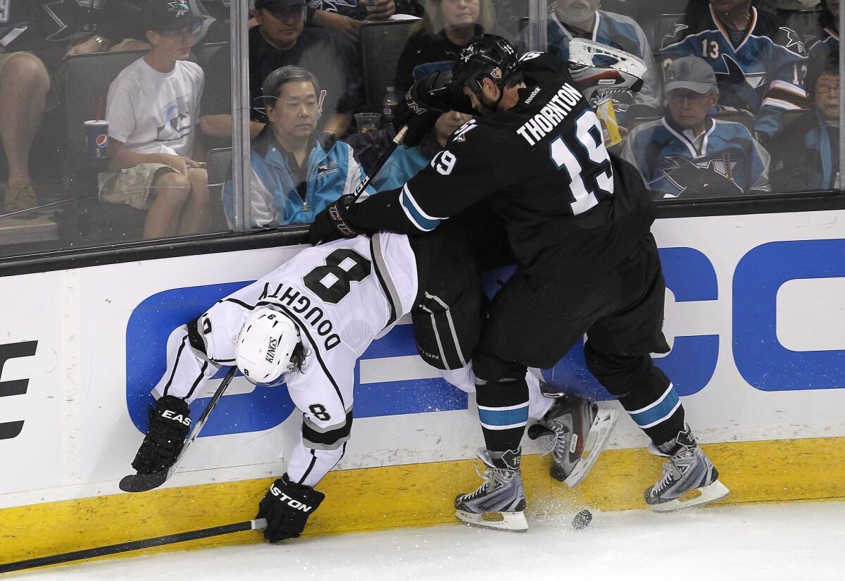 Sharks center Joe Thornton upends Kings defenseman Drew Doughty along the boards in the second period of Game 3 on Saturday night.