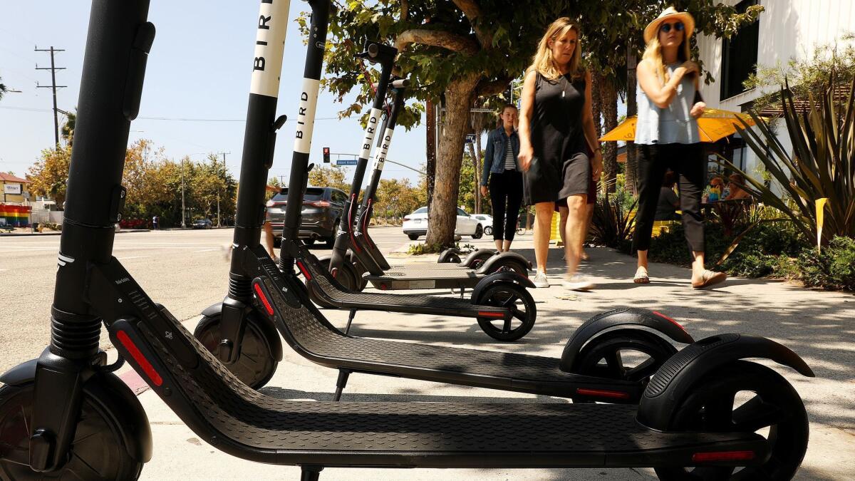 A row of electric scooters wait for customers near the corner of Abbot Kinney and Venice Boulevards in Venice, Calif. on August 15.