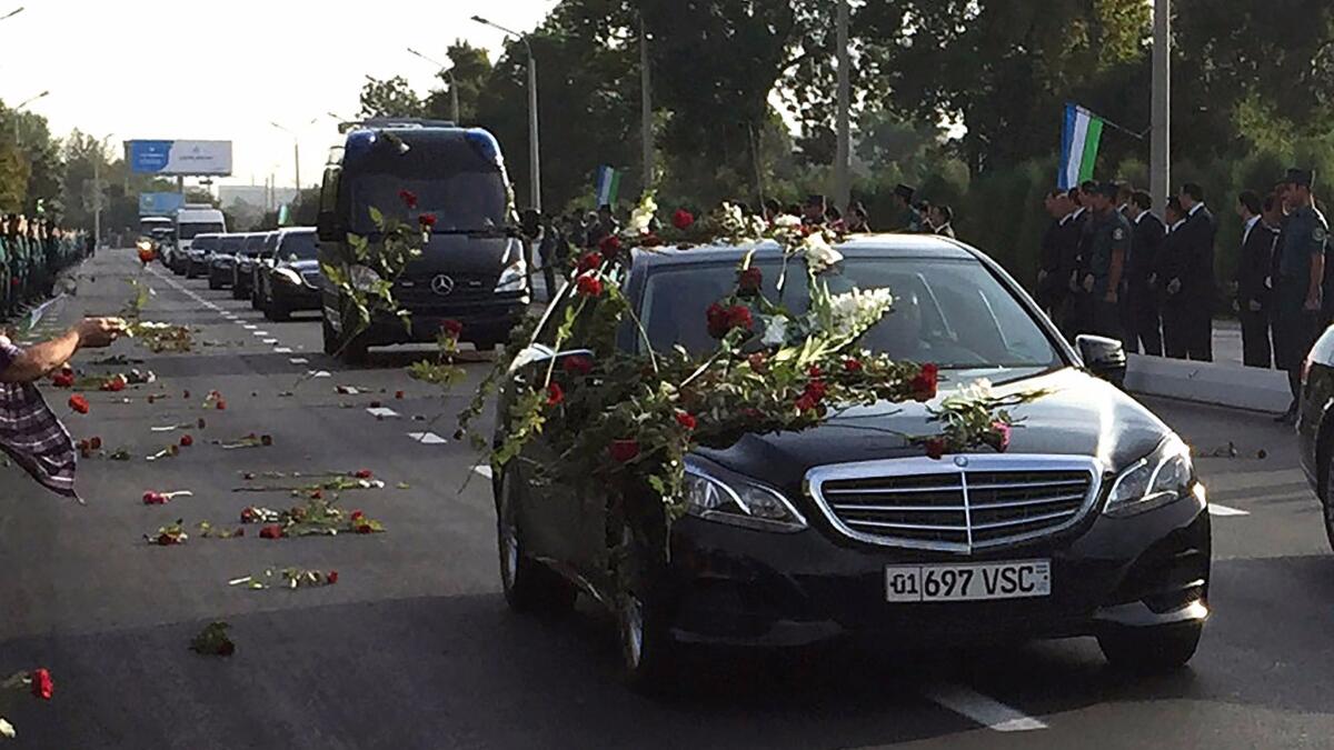 Flowers are thrown at the funeral cortege carrying the body of Uzbekistan's longtime leader, Islam Karimov, to the airport in Tashkent.