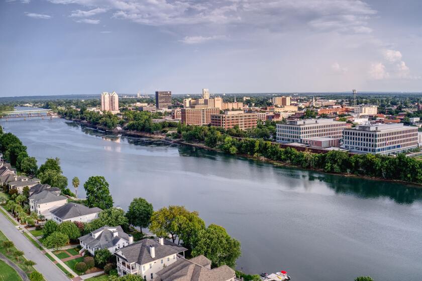 The skyline of downtown Augusta, Ga., reflects in the Savannah River.