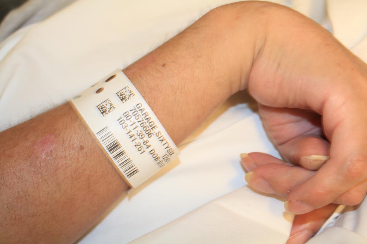Garage’s hospital bracelet reads: “GARAGE, SIXTYSIX,” the naming convention used to identify the unconscious man.