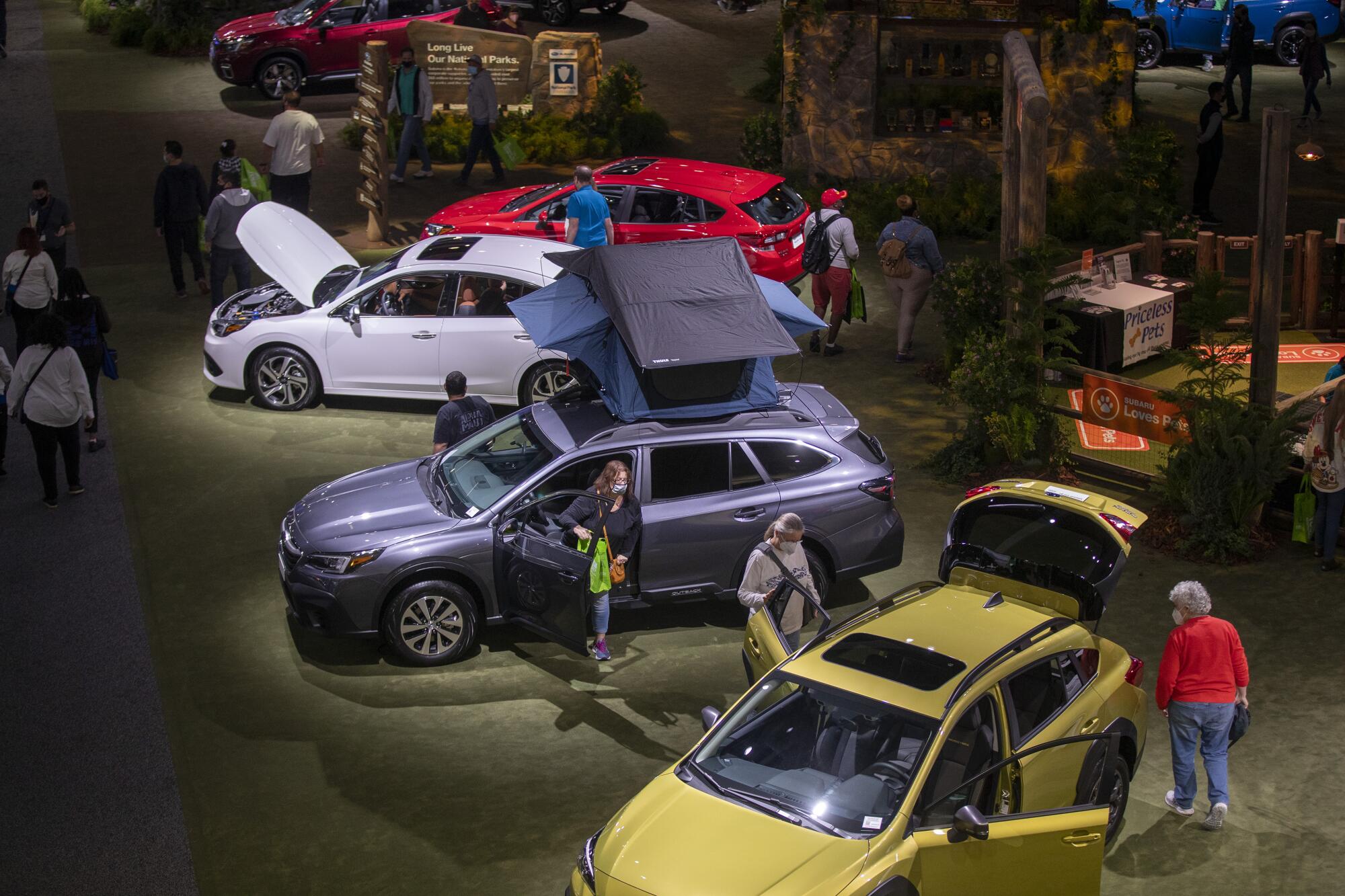 Automotive enthusiasts check out Subaru vehicles on the first day of the L.A. Auto Show at the Convention Center.