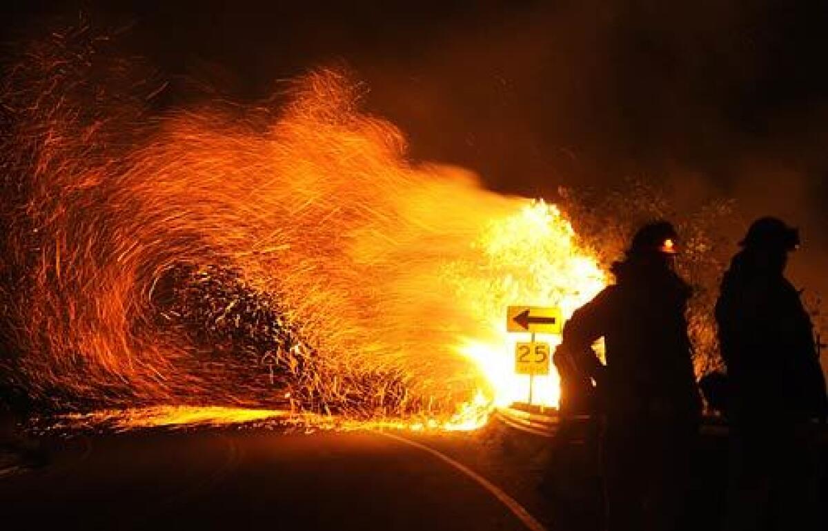 Flames from the Station fire sweep across Angeles Crest Highway.