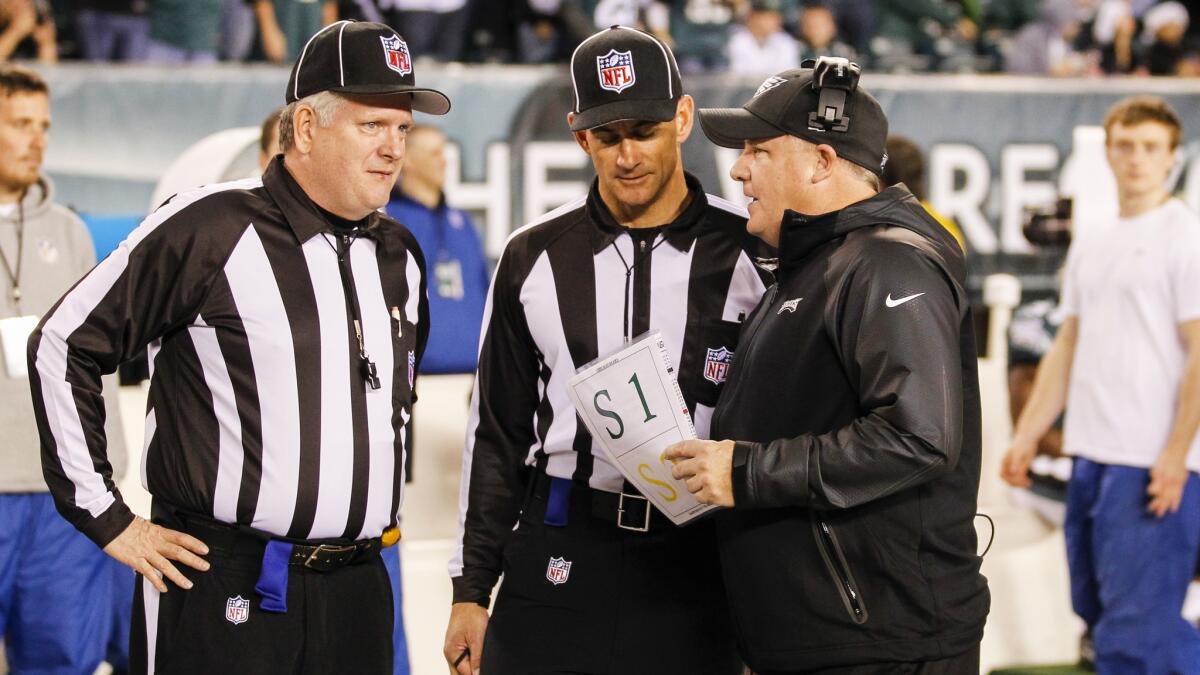 Philadelphia Eagles head coach Chip Kelly speaks to NFL referees before a game against the Chicago Bears in December. Kelly wants to make sure the referees do their part in keeping the game moving at a brisk pace.