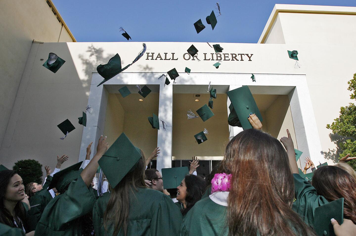 Grads celebrate after the Providence High School graduation at Forest Lawn Hollywood Hills' Hall of Liberty in Los Angeles on Saturday, June 9, 2012.