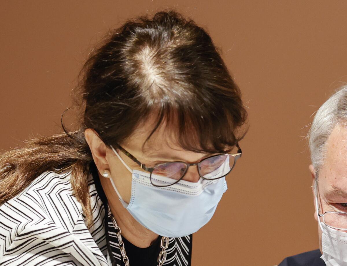 FILE - Finland's Foreign Minister Pekka Haavisto, right, and Special Representative of the Secretary General of the United Nations for Afghanistan, Deborah Lyons, left, wear protective masks prior to the plenary session of the 2020 Afghanistan Conference at the United Nations in Geneva, Switzerland, Tuesday, Nov. 24, 2020. Lyons is leaving her post as the U.N. chief’s special representative and gave a farewell statement released to the media on Thursday, June 16, 2022. She said the Afghanistan today is a very different country from the one she encountered two years ago.(Denis Balibouse/Pool Photo via AP, File)
