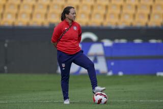 Twila Kilgore, assistant coach on the U.S. team watches players warm up prior to a CONCACAF.