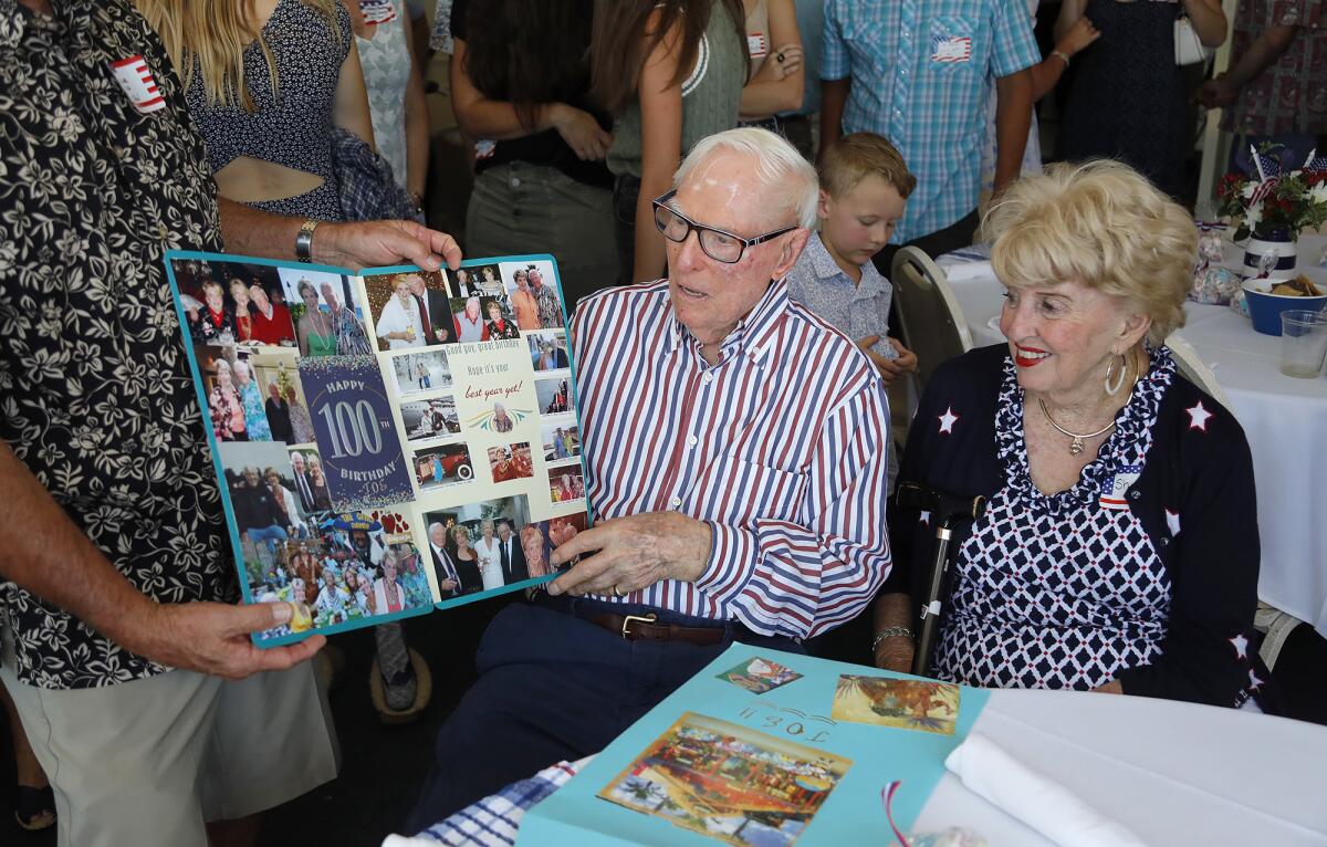 Joseph King looks at a 100th birthday card with girlfriend Shirley.