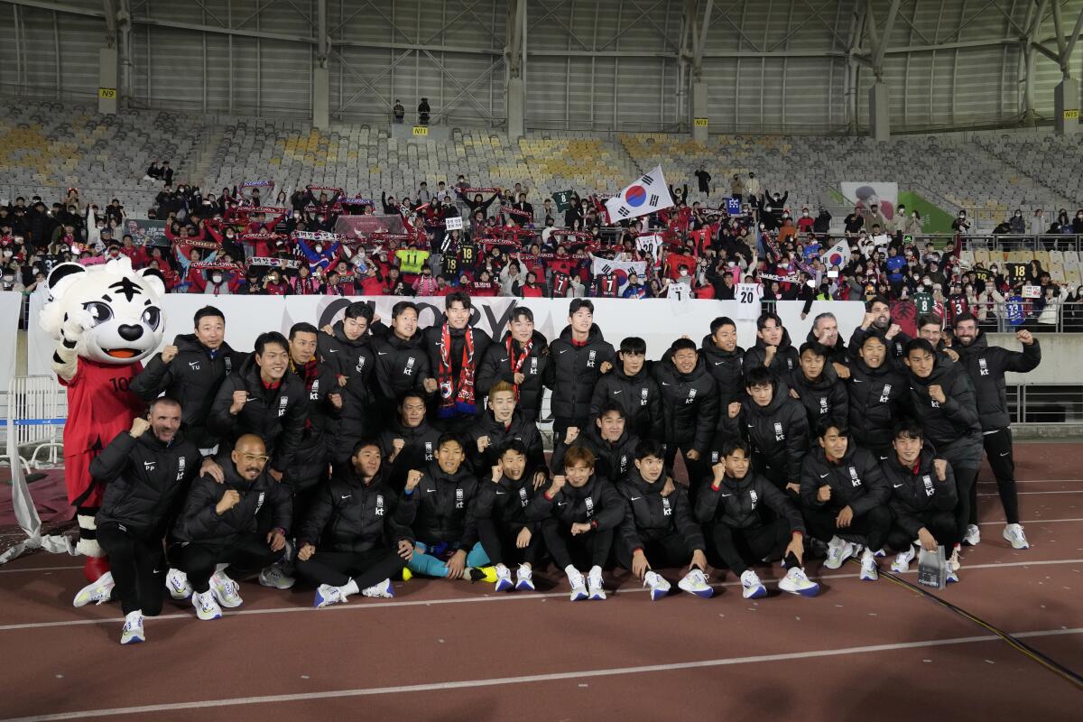 Members of South Korean national soccer team pose for photographers before leaving for the Qatar 2022 World Cup, after their friendly soccer match against Iceland at Hwaseong Sports Complex Main Stadium in Hwaseong, South Korea, Friday, Nov. 11, 2022. (AP Photo/Lee Jin-man)
