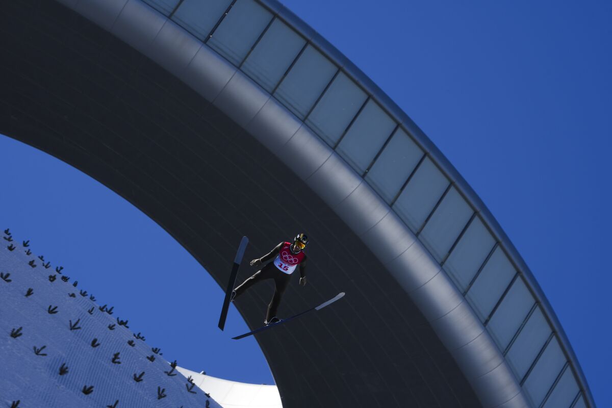 Fatih Arda Ipcioglu, of Turkey, soars through the air during the men's normal hill individual ski jumping qualification round at the 2022 Winter Olympics, Saturday, Feb. 5, 2022, in Zhangjiakou, China. (AP Photo/Matthias Schrader)