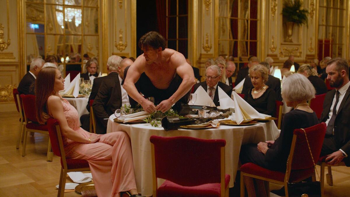Terry Notary, center, in a scene from "The Square." The film is nominated for a foreign picture Oscar.